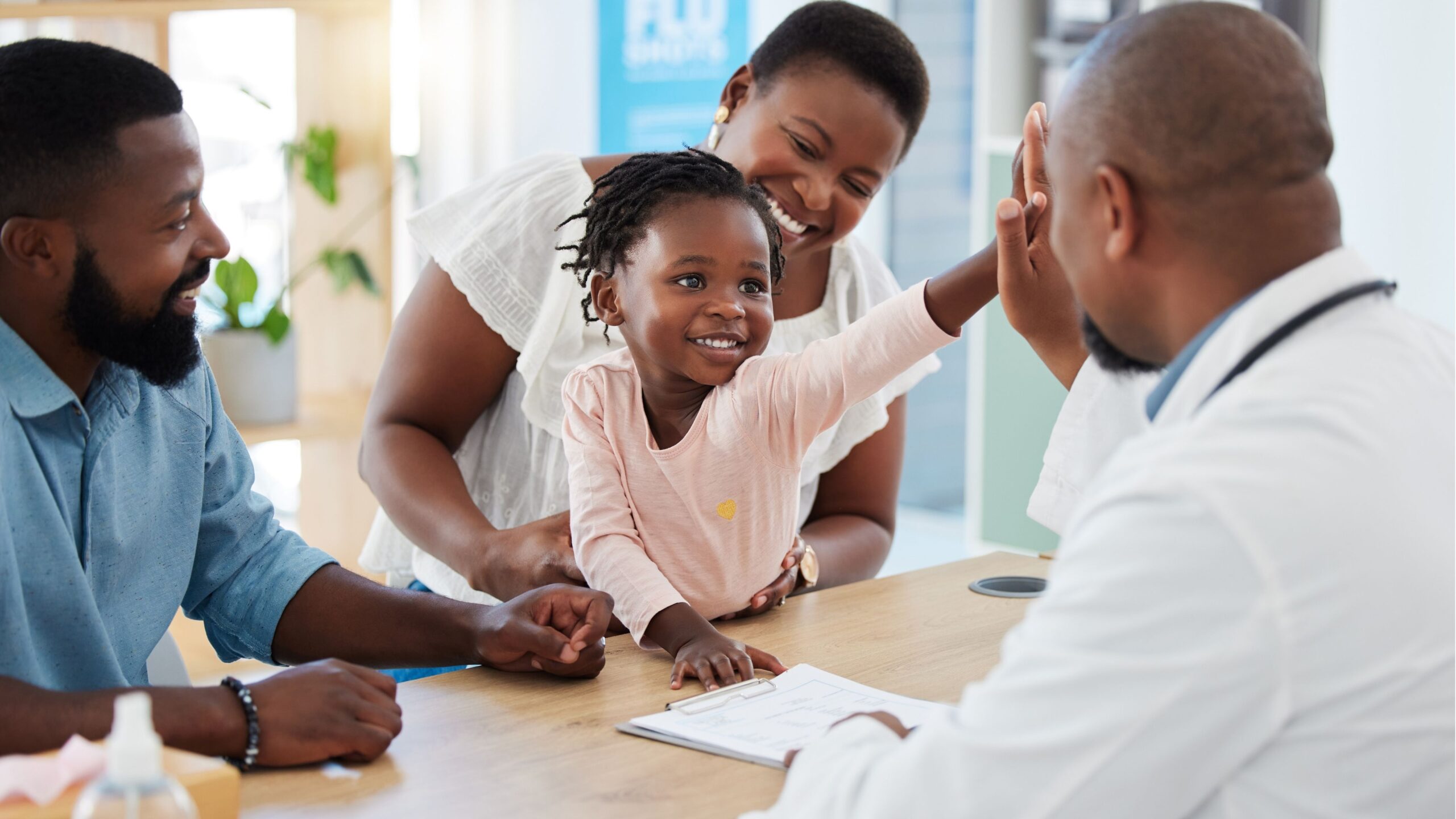 Child receiving a high-five from a healthcare provider